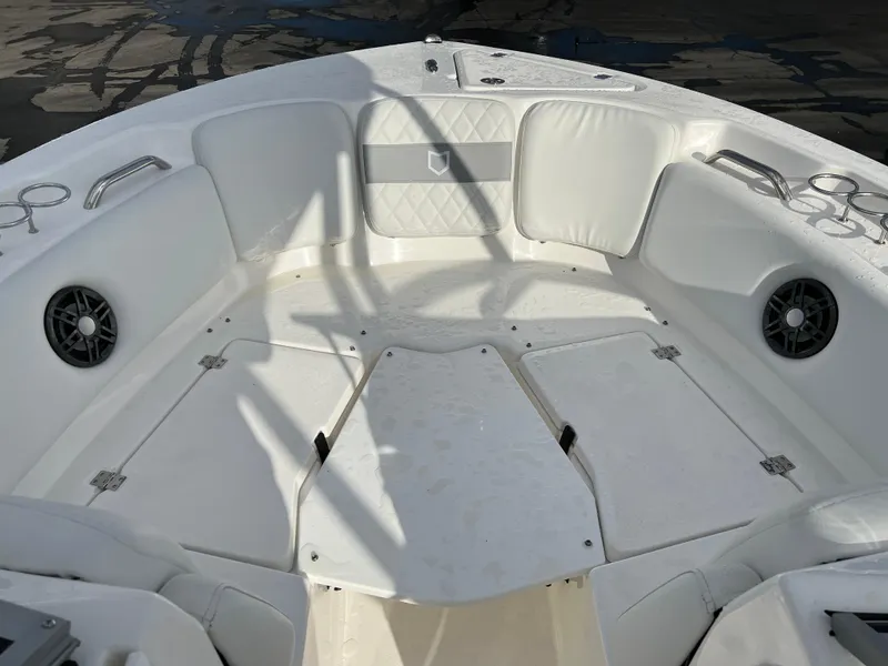 Slide: The Image of 2024 Sea Fox 228 Traveler boat interior with white cushioned seating and storage compartments. - 16