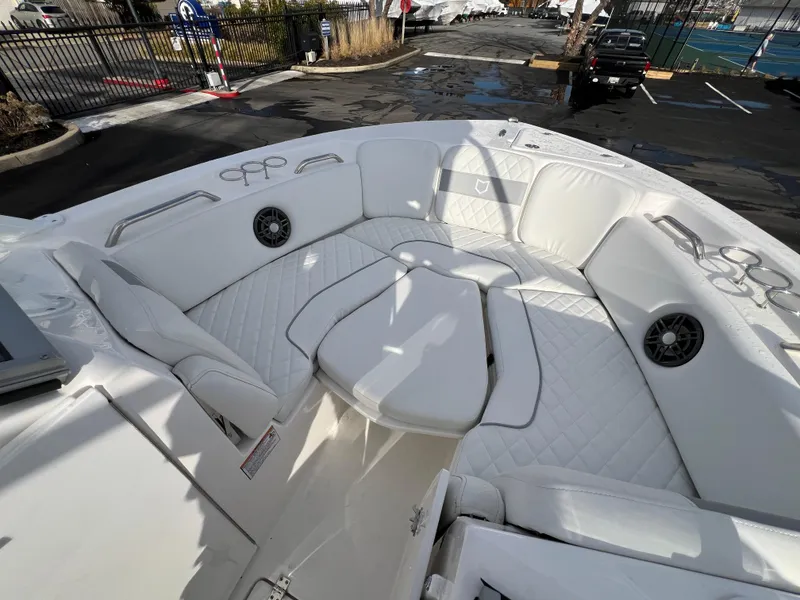 Slide: The Image of 2024 Sea Fox 228 Traveler boat interior with white cushioned seating and speakers. - 27