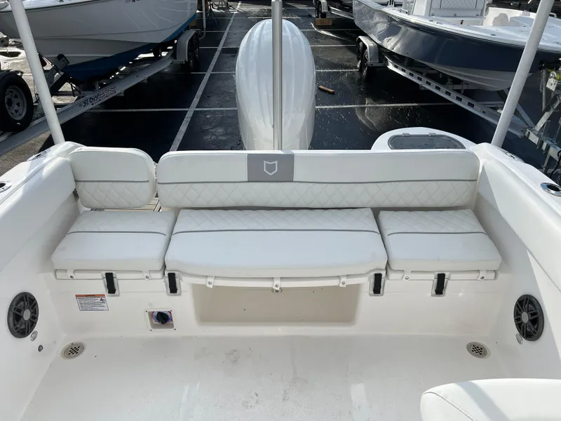 Slide: The Image of 2024 Sea Fox 228 Traveler boat interior with white cushioned seating. - 30