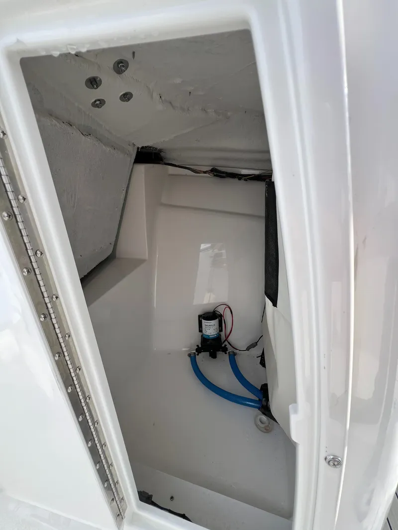 Slide: The Image of 2024 Sea Fox 228 Traveler storage compartment with pump and wiring. - 31