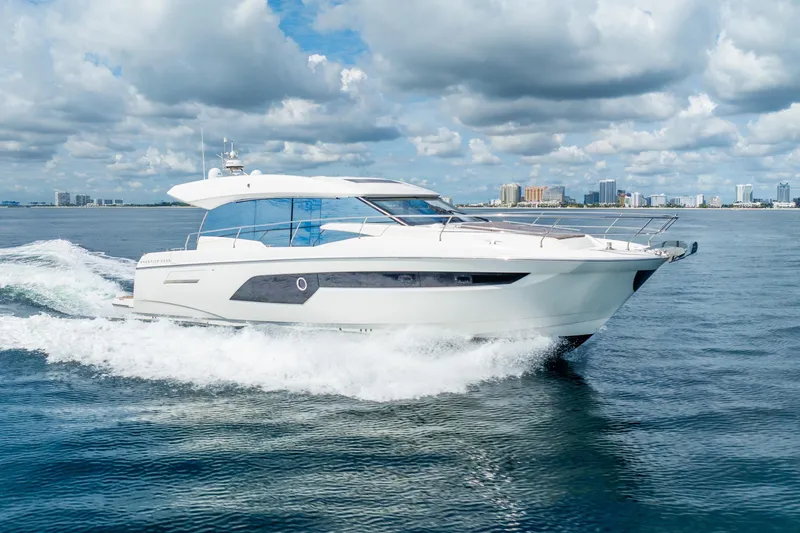 The Image of Luxurious 2018 Prestige 520S yacht cruising on open water under a cloudy sky. - 0