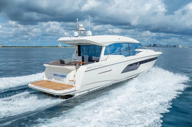 Slide: The Image of 2018 Prestige 520S yacht cruising on open water under cloudy skies. - 1
