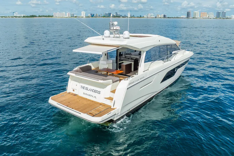 Slide: The Image of Luxury 2018 Prestige 520S yacht cruising near Sarasota, Florida, with city skyline in background. - 10
