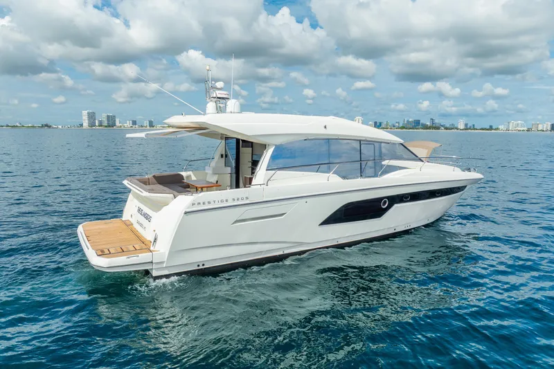 Slide: The Image of 2018 Prestige 520S yacht cruising on open water under a partly cloudy sky. - 11