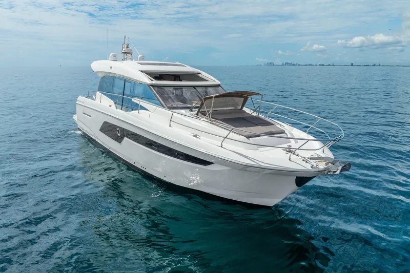 Slide: The Image of 2018 Prestige 520S yacht cruising on open sea under clear skies. - 14