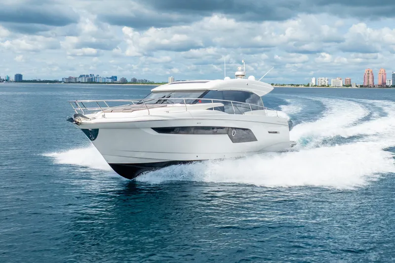 Slide: The Image of 2018 Prestige 520S yacht cruising on open water under cloudy skies. - 2