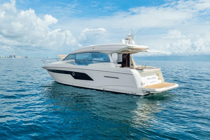 Slide: The Image of 2018 Prestige 520S yacht cruising on open water under a partly cloudy sky. - 20