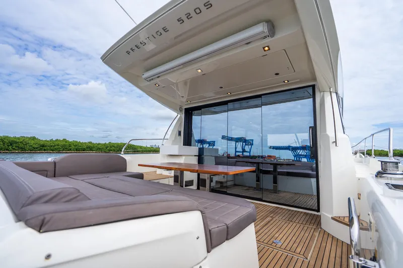 Slide: The Image of Luxury 2018 Prestige 520S yacht with spacious outdoor seating and sleek design. - 25