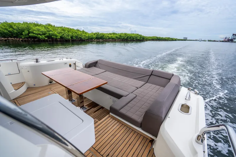 Slide: The Image of Luxurious 2018 Prestige 520S yacht with elegant deck seating and scenic water view. - 26