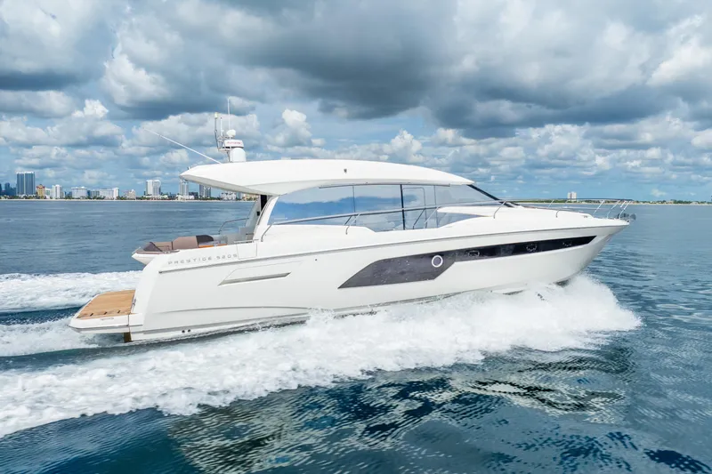 Slide: The Image of 2018 Prestige 520S yacht cruising on open water under cloudy skies. - 3
