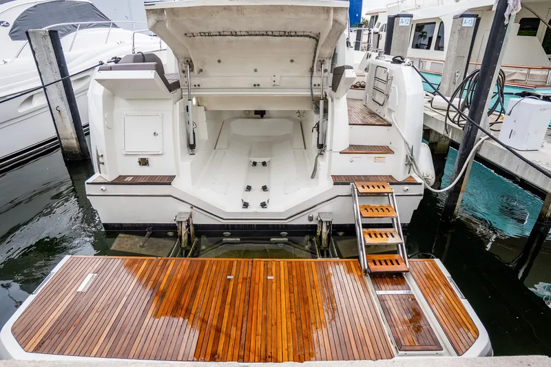 Slide: The Image of Luxury 2018 Prestige 520S yacht with open stern and wooden deck at marina. - 30