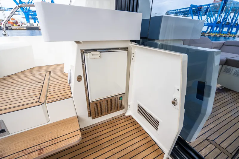 Slide: The Image of 2018 Prestige 520S yacht with open mini fridge on teak deck. - 31