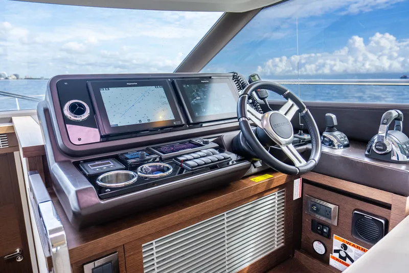 Slide: The Image of Cockpit of 2018 Prestige 520S yacht with advanced navigation controls and steering wheel. - 42
