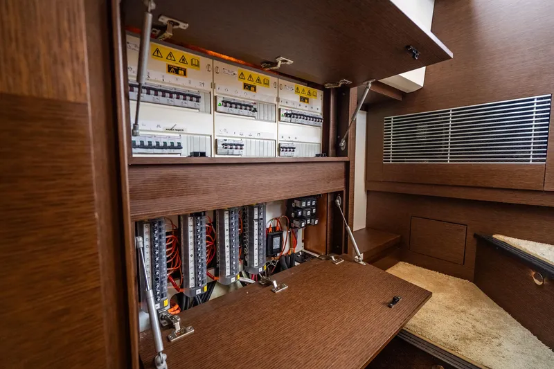 Slide: The Image of Electrical panel inside 2018 Prestige 520S yacht, showcasing circuit breakers and wiring. - 45