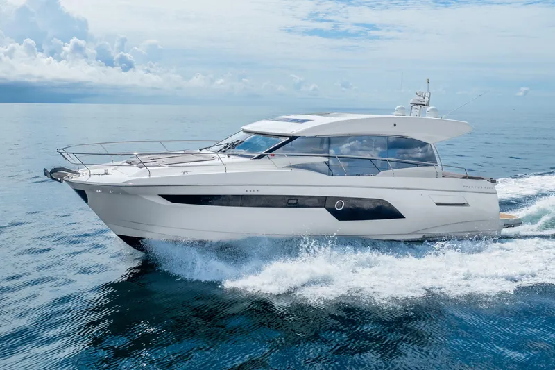 Slide: The Image of 2018 Prestige 520S yacht cruising on open water under a cloudy sky. - 5