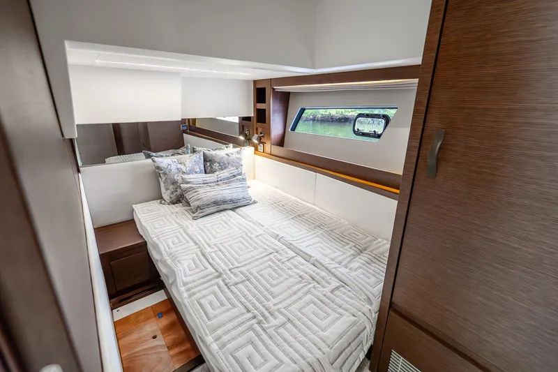 Slide: The Image of Luxurious cabin interior of 2018 Prestige 520S yacht with elegant bedding and wood accents. - 53