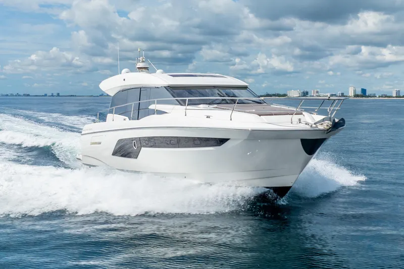 Slide: The Image of 2018 Prestige 520S yacht cruising on open water under a partly cloudy sky. - 6