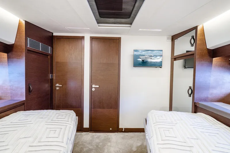 Slide: The Image of Luxurious 2018 Prestige 520S yacht cabin with twin beds and elegant wood finishes. - 60