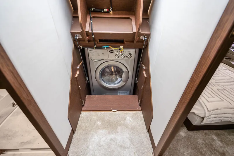 Slide: The Image of Compact laundry area in 2018 Prestige 520S yacht with built-in washing machine. - 61