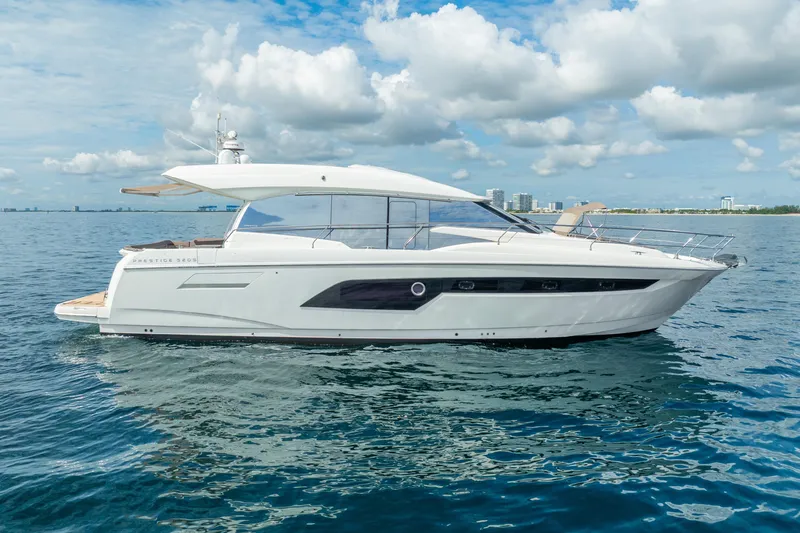 Slide: The Image of 2018 Prestige 520S yacht cruising on calm blue waters under a partly cloudy sky. - 9
