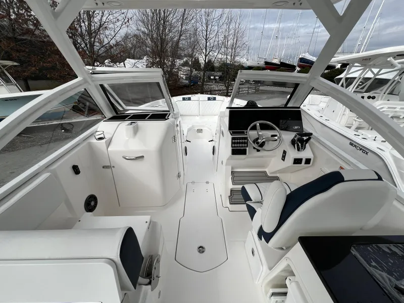 Slide: The Image of 2024 Sea Fox 268 Traveler boat interior with modern helm and seating. - 14