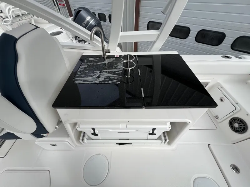 Slide: The Image of 2024 Sea Fox 268 Traveler boat interior with sleek black countertop and integrated sink. - 15