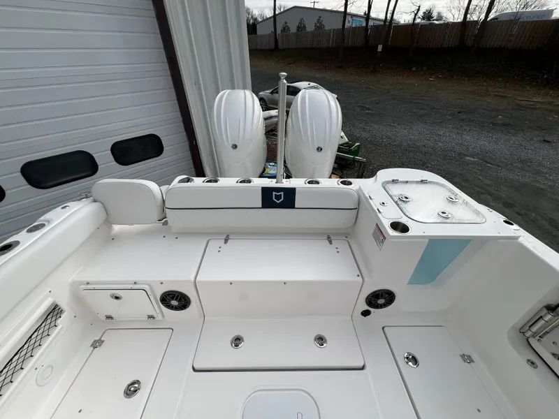 Slide: The Image of 2024 Sea Fox 268 Traveler boat interior with dual engines, white seating, and storage compartments. - 19