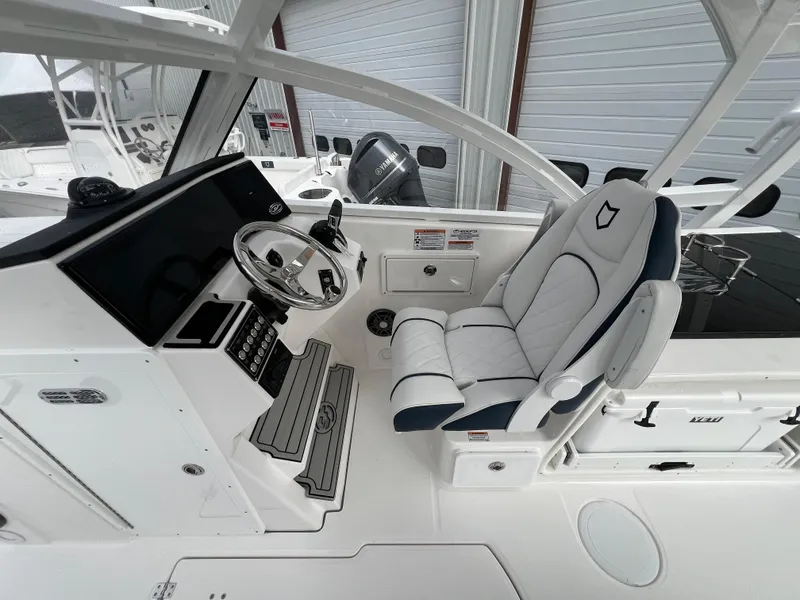 Slide: The Image of 2024 Sea Fox 268 Traveler boat cockpit with modern steering and comfortable seating. - 8