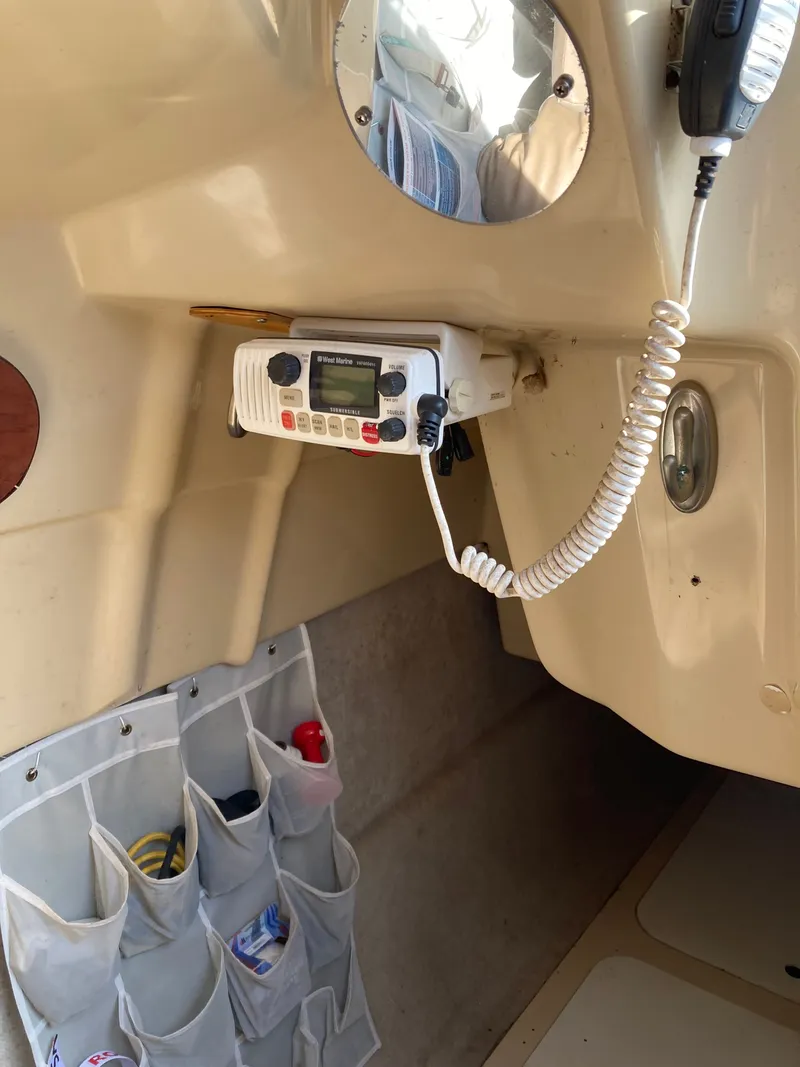 Slide: The Image of Interior of a MacGregor 26 boat with radio and storage pockets. - 11