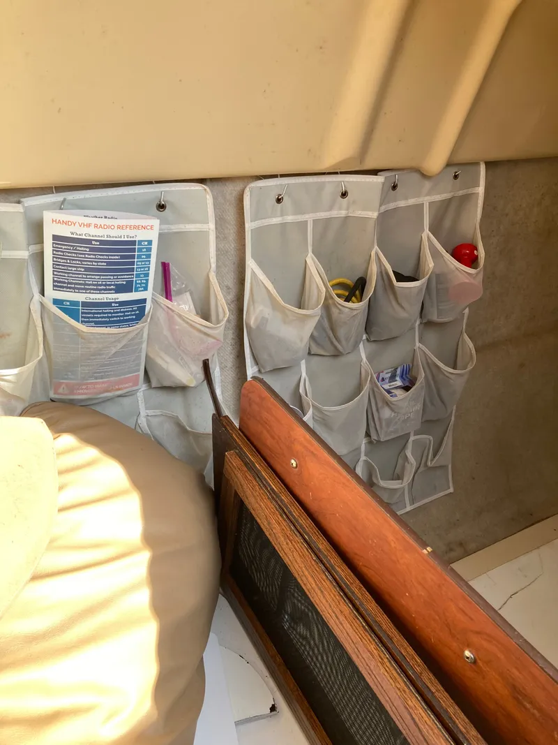 Slide: The Image of Interior of a 2007 MacGregor 26 sailboat with handy storage pockets. - 17