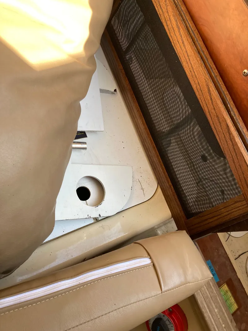 Slide: The Image of Interior of a 2007 MacGregor 26 boat with upholstery and wood paneling. - 19