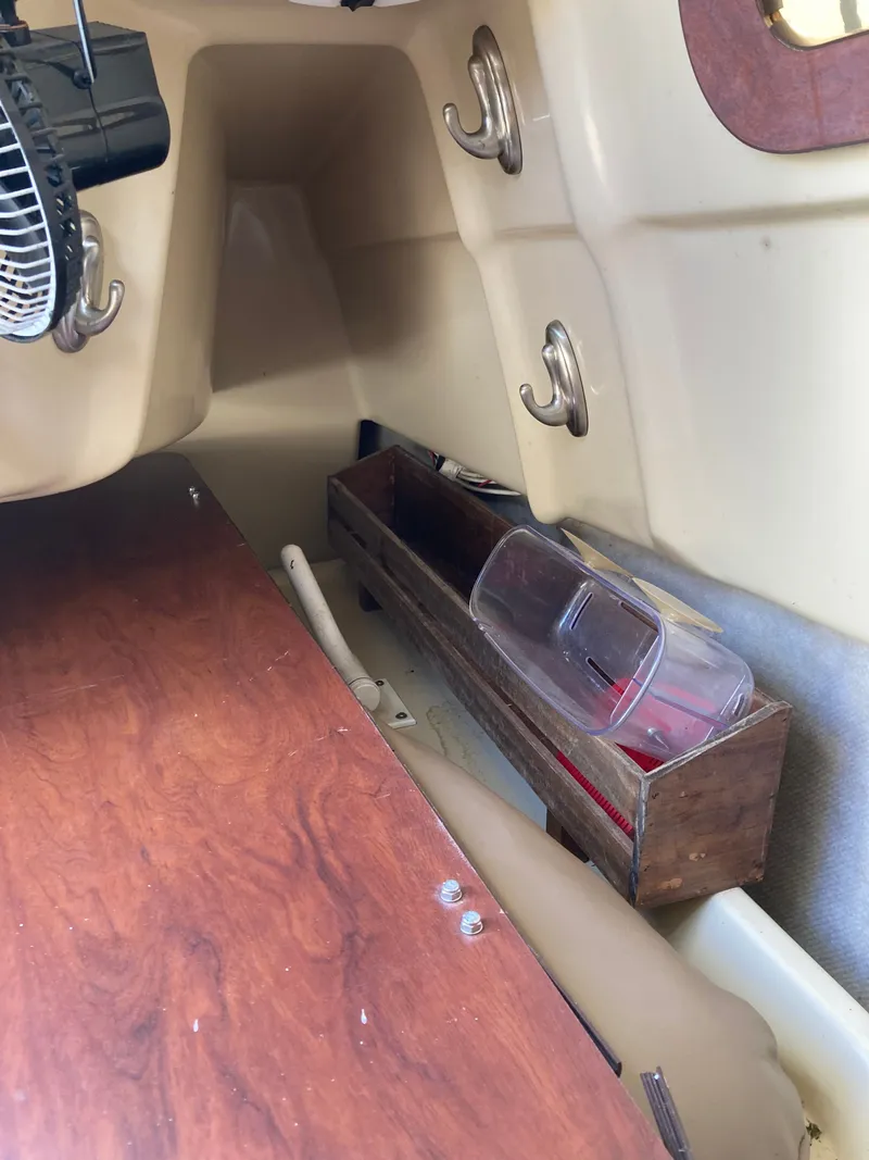 Slide: The Image of Interior of a 2007 MacGregor 26 with wood details and storage. - 20