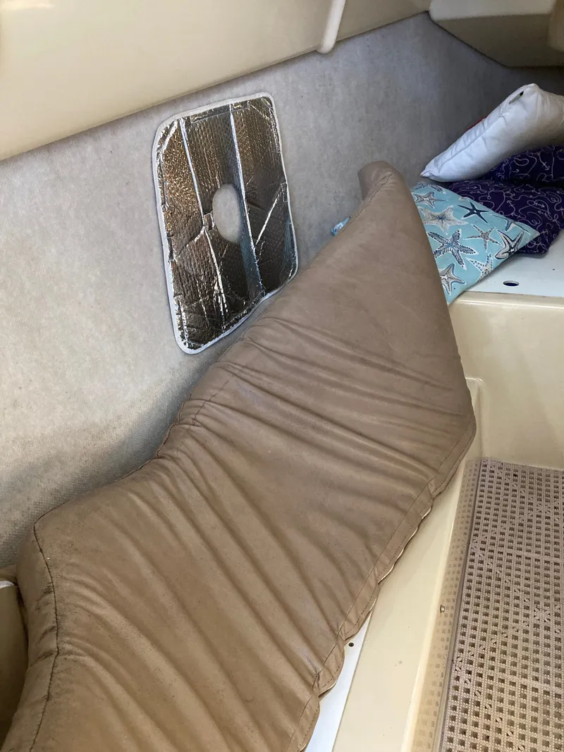 Slide: The Image of Interior of a 2007 MacGregor 26 sailboat with cushion and pillows. - 23