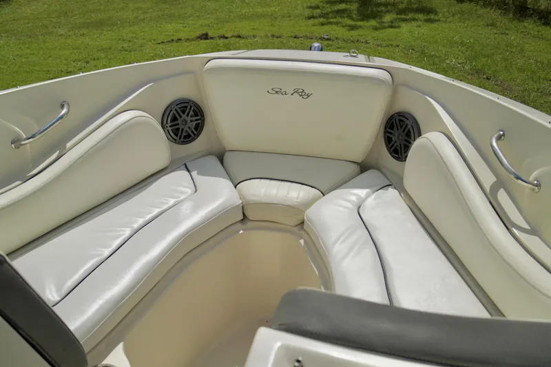 Slide: The Image of 2008 Sea Ray 230 Select Fission boat interior with white cushioned seating. - 10