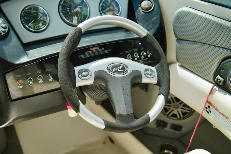 Slide: The Image of Steering wheel and dashboard of a 2008 Sea Ray 230 Select Fission boat. - 19