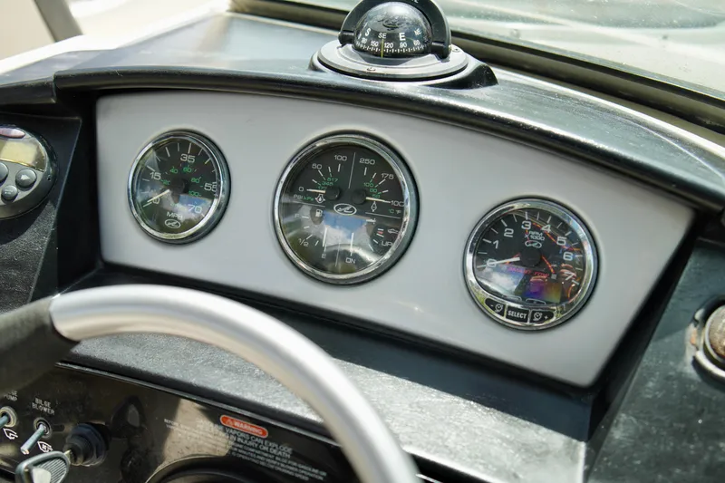 Slide: The Image of Dashboard of a 2008 Sea Ray 230 Select Fission boat with gauges and compass. - 21