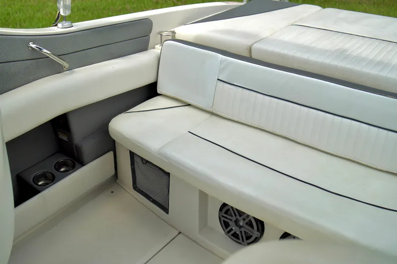 Slide: The Image of Interior seating of a 2008 Sea Ray 230 Select Fission boat with cup holders and speaker. - 25