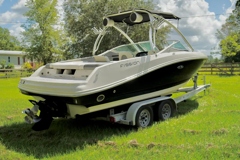Slide: The Image of 2008 Sea Ray 230 Select Fission boat on a trailer in a grassy field. - 31