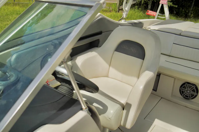 Slide: The Image of 2008 Sea Ray 230 Select Fission boat interior with captain's chair and steering wheel. - 14