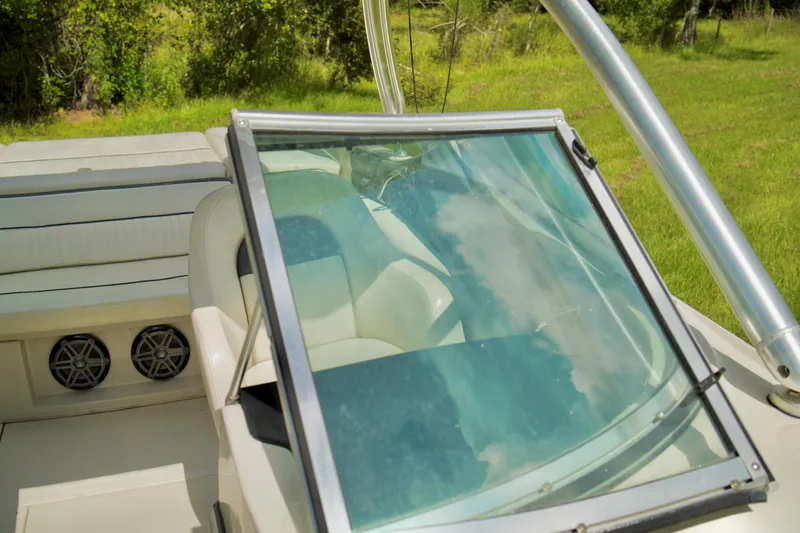 Slide: The Image of 2008 Sea Ray 230 Select Fission boat interior with windshield and seating. - 15