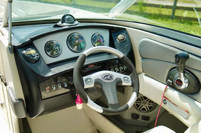 Slide: The Image of 2008 Sea Ray 230 Select Fission boat dashboard and steering wheel. - 18