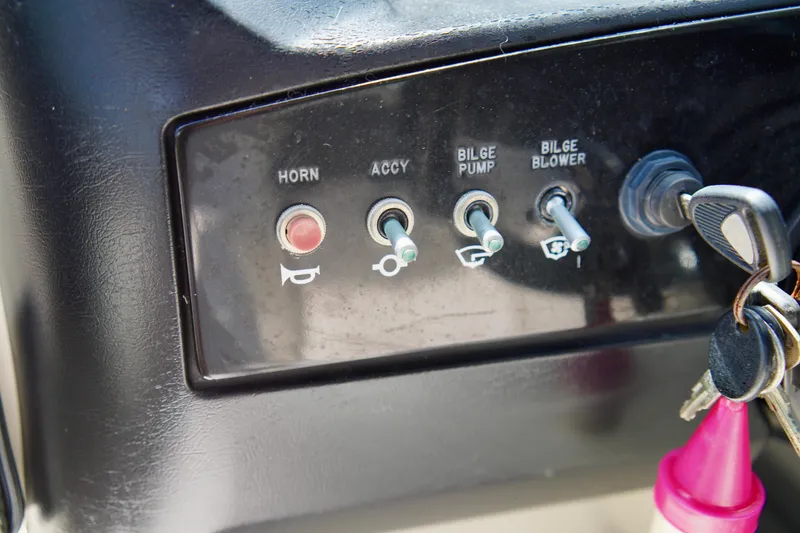 Slide: The Image of Control panel of a 2008 Sea Ray 230 Select Fission boat with switches and keys. - 22