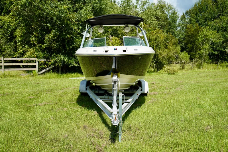 Slide: The Image of 2008 Sea Ray 230 Select Fission boat on trailer in grassy area. - 4