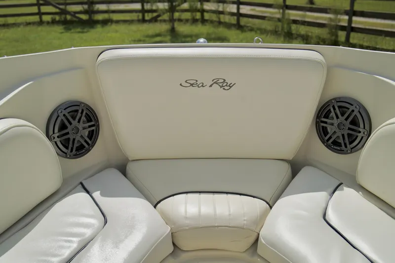 Slide: The Image of 2008 Sea Ray 230 Select Fission boat interior with white leather seating and built-in speakers. - 7