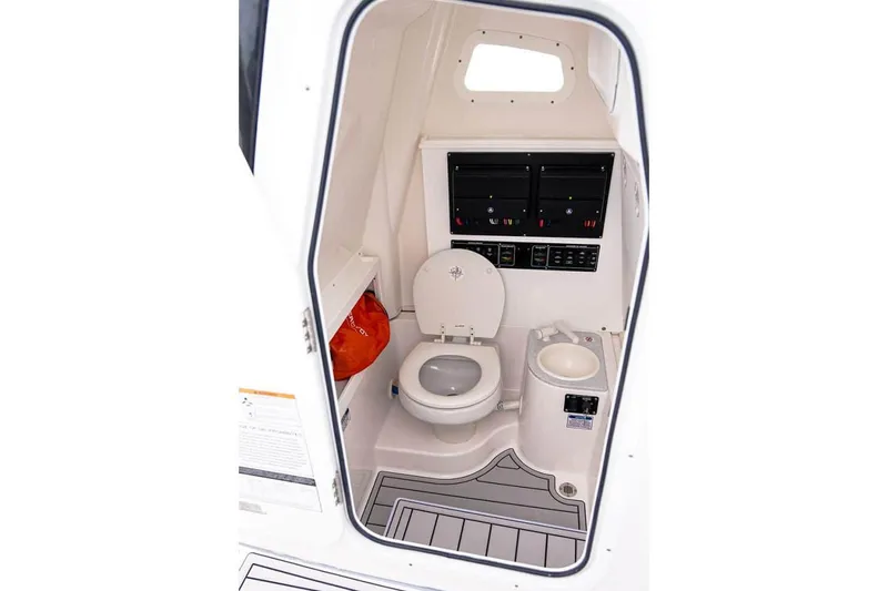Slide: The Image of Manufacturer Provided Image: Interior of 2025 Sea Fox 282 Hybrid LT boat, featuring a compact marine toilet. - 8