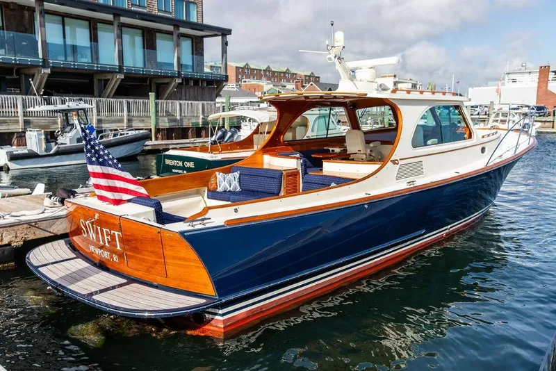 The Image of 2005 Hinckley Talaria 40 yacht docked, featuring elegant design and American flag. - 0