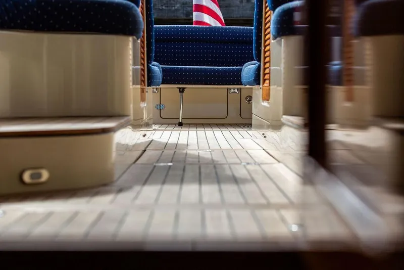 Slide: The Image of Interior view of 2005 Hinckley Talaria 40 yacht with wooden flooring and blue seating. - 21