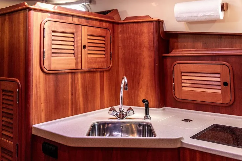 Slide: The Image of Luxurious 2005 Hinckley Talaria 40 yacht interior with elegant wood cabinetry and modern sink. - 32