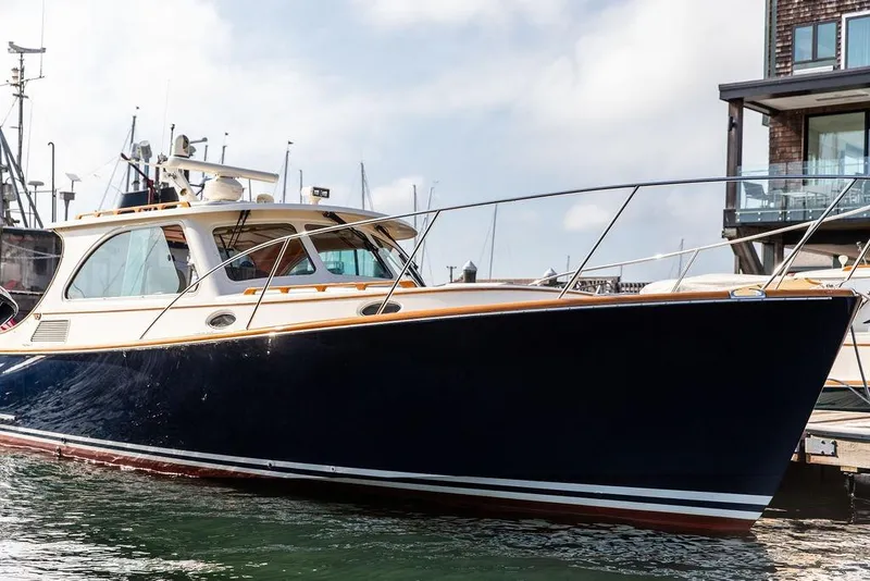 Slide: The Image of 2005 Hinckley Talaria 40 yacht docked in a marina, showcasing sleek design and luxury. - 5