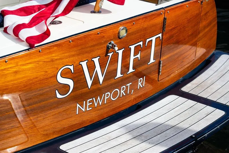 Slide: The Image of 2005 Hinckley Talaria 40 boat named "Swift" in Newport, RI, with American flag. - 6